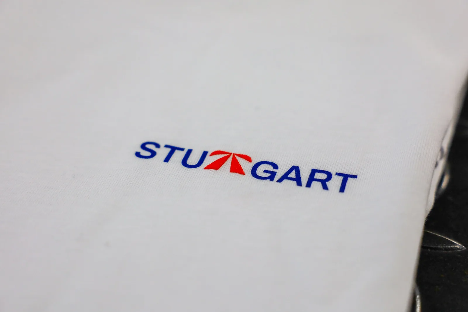 The Autobahn Tee by Roadbloc, white with the blue road sign graphic