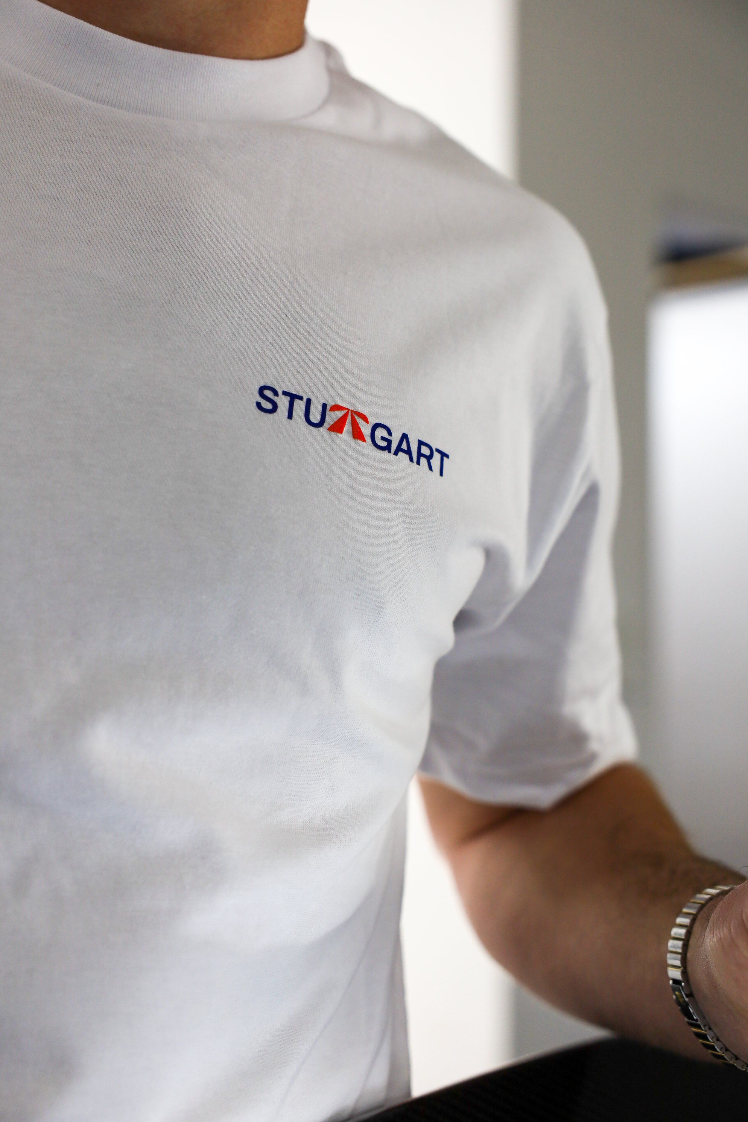 The Autobahn Tee by Roadbloc, white with the blue road sign graphic