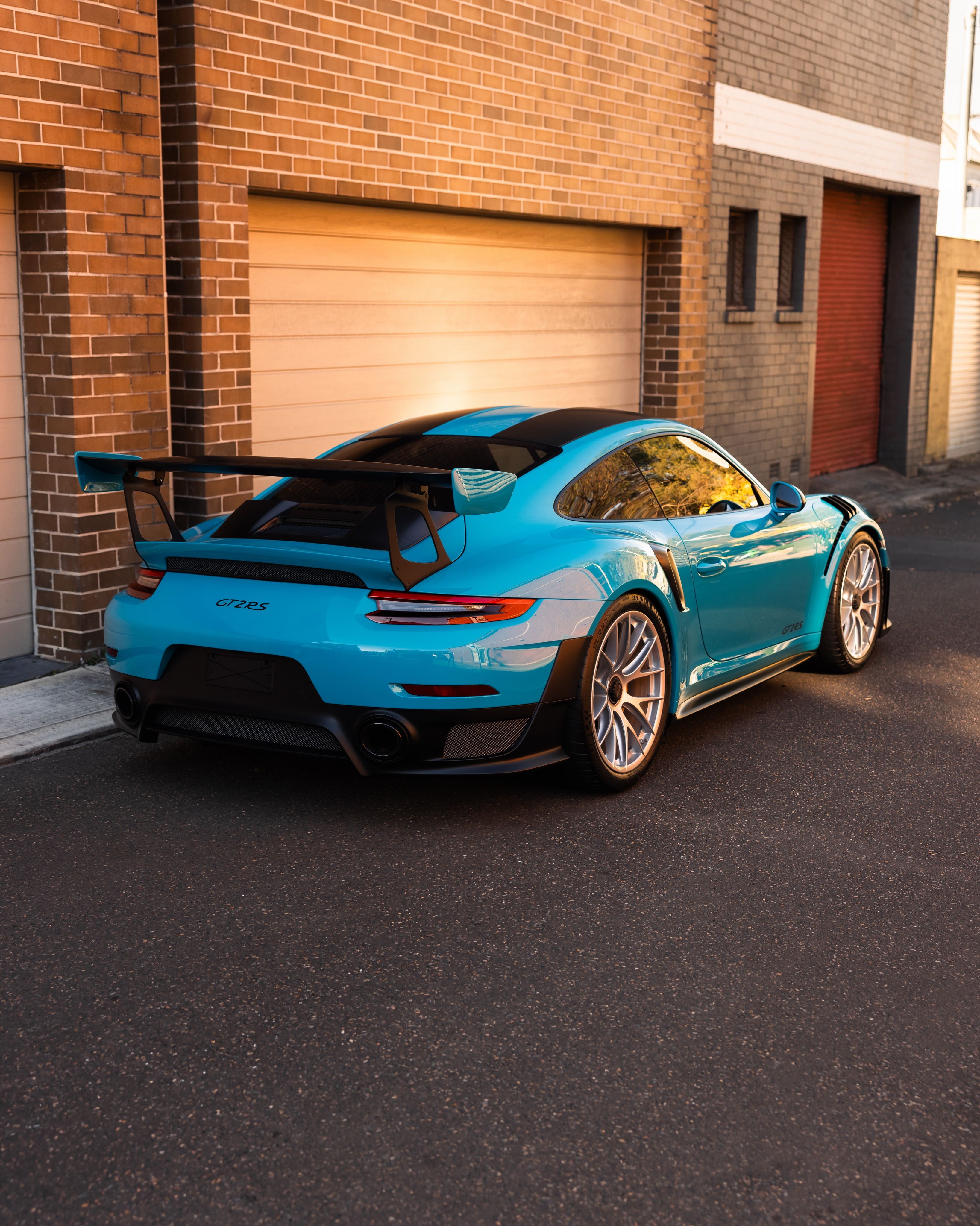Miami blue Porsche 911 GT2 RS from the rear three-quarter
