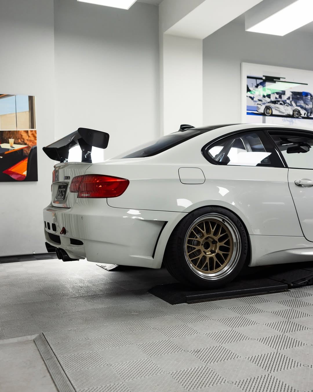 White BMW E92 M3 from the rear three-quarter in the studio