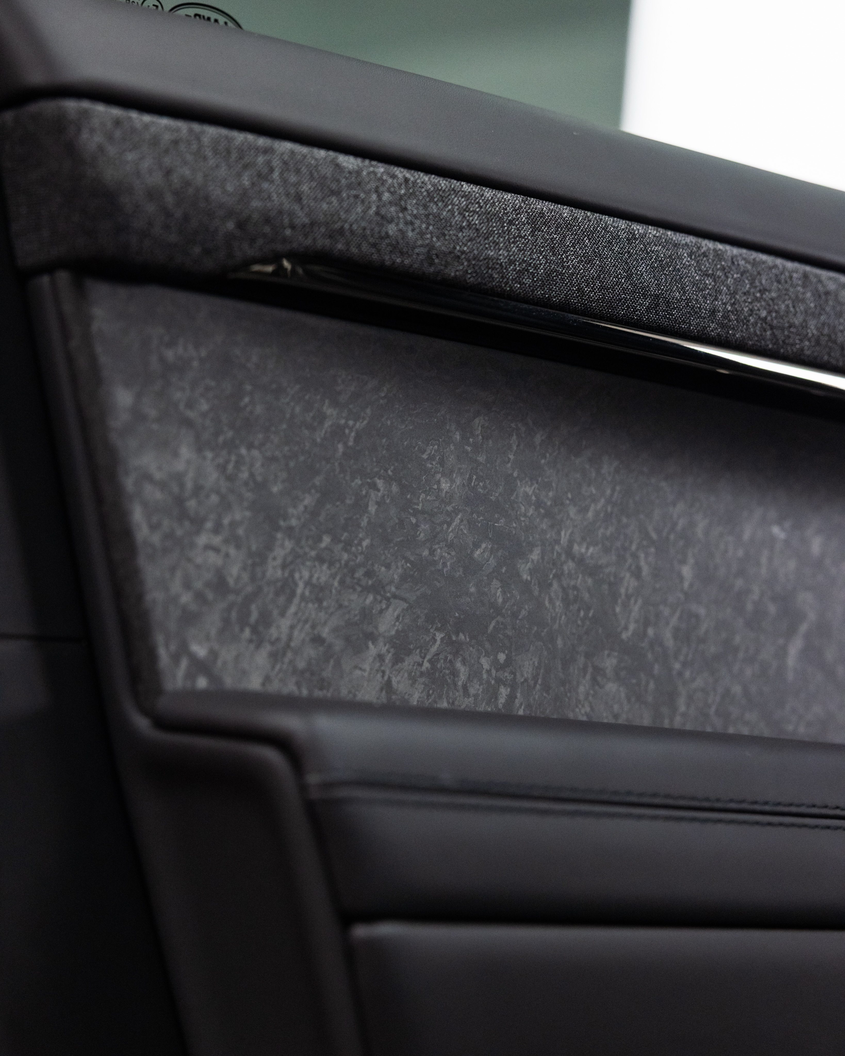 The Range Rover's door card, its carbon insert and chrome strip protected