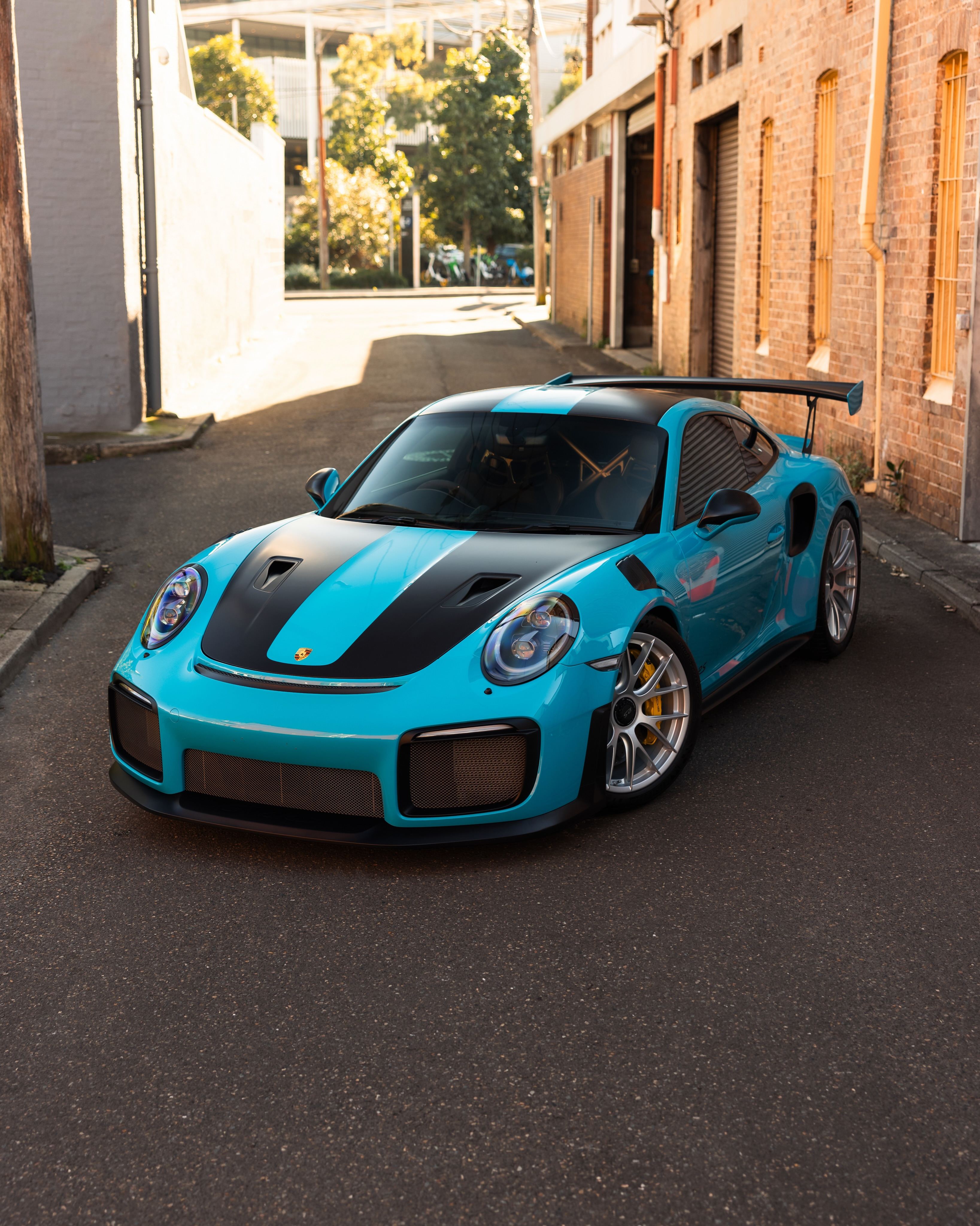 Miami blue Porsche 911 GT2 RS from the front three-quarter in a lane