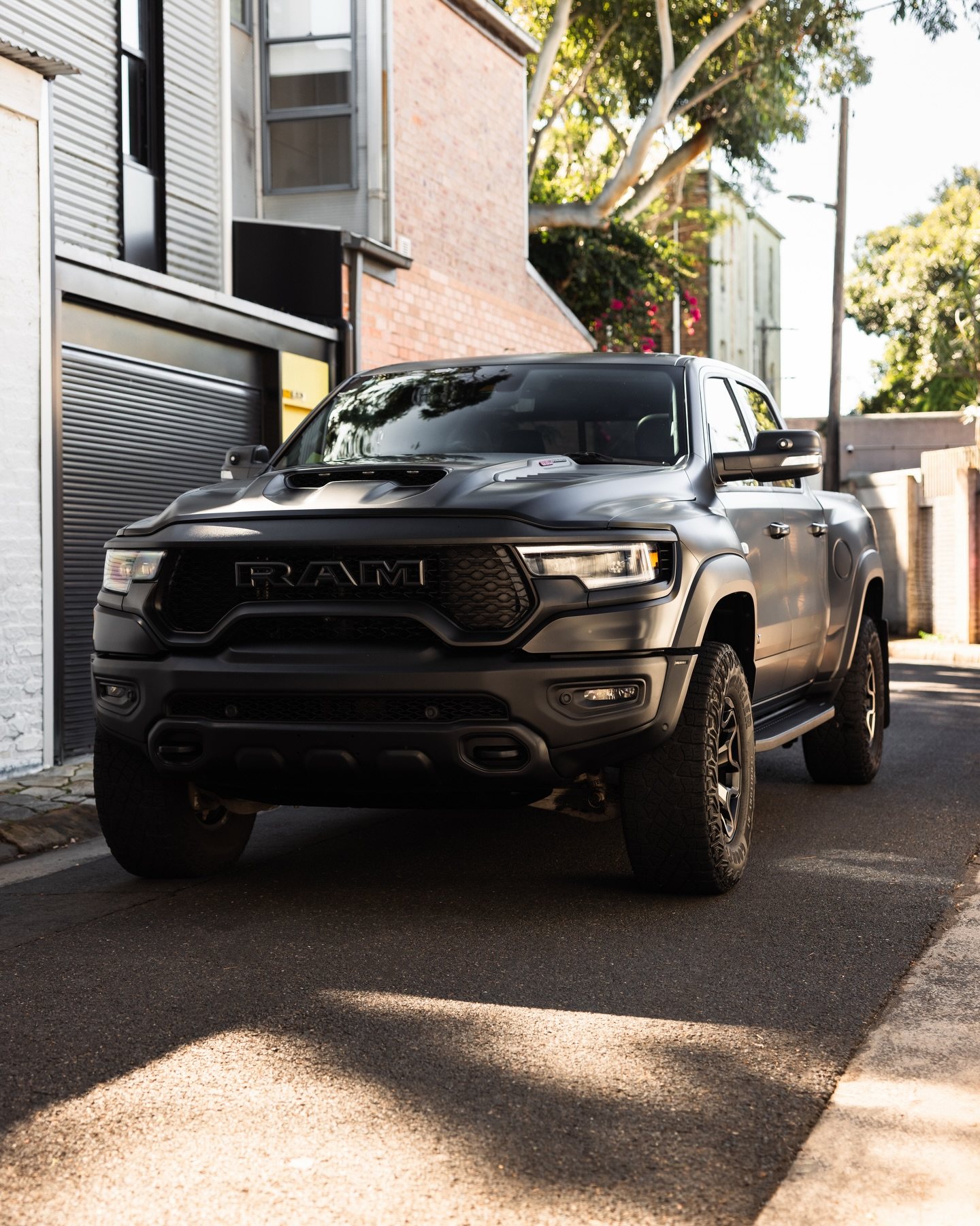 Satin black Ram TRX from the front in a sunlit Sydney lane