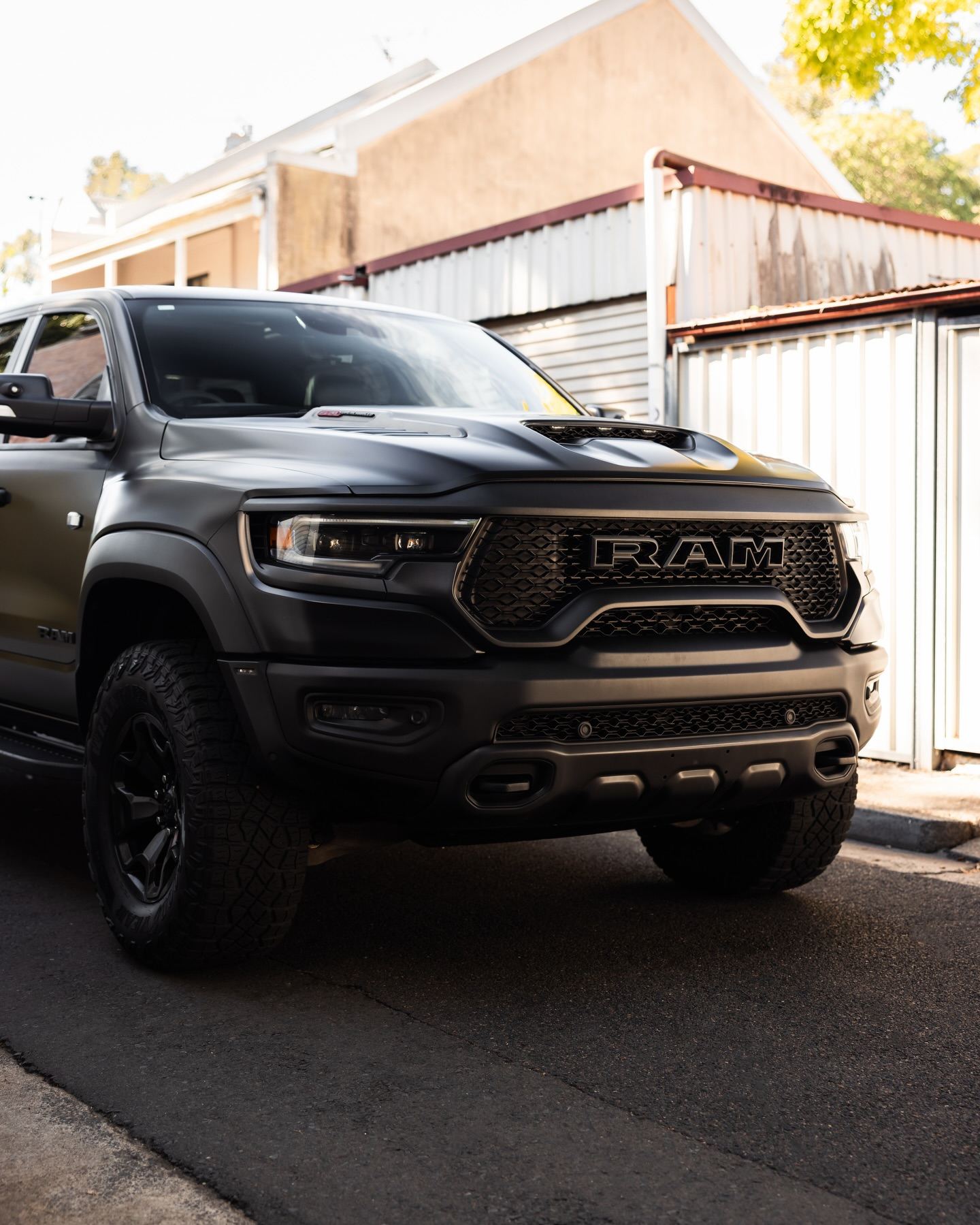 Black RAM TRX pickup in a Sydney lane, front three-quarter view